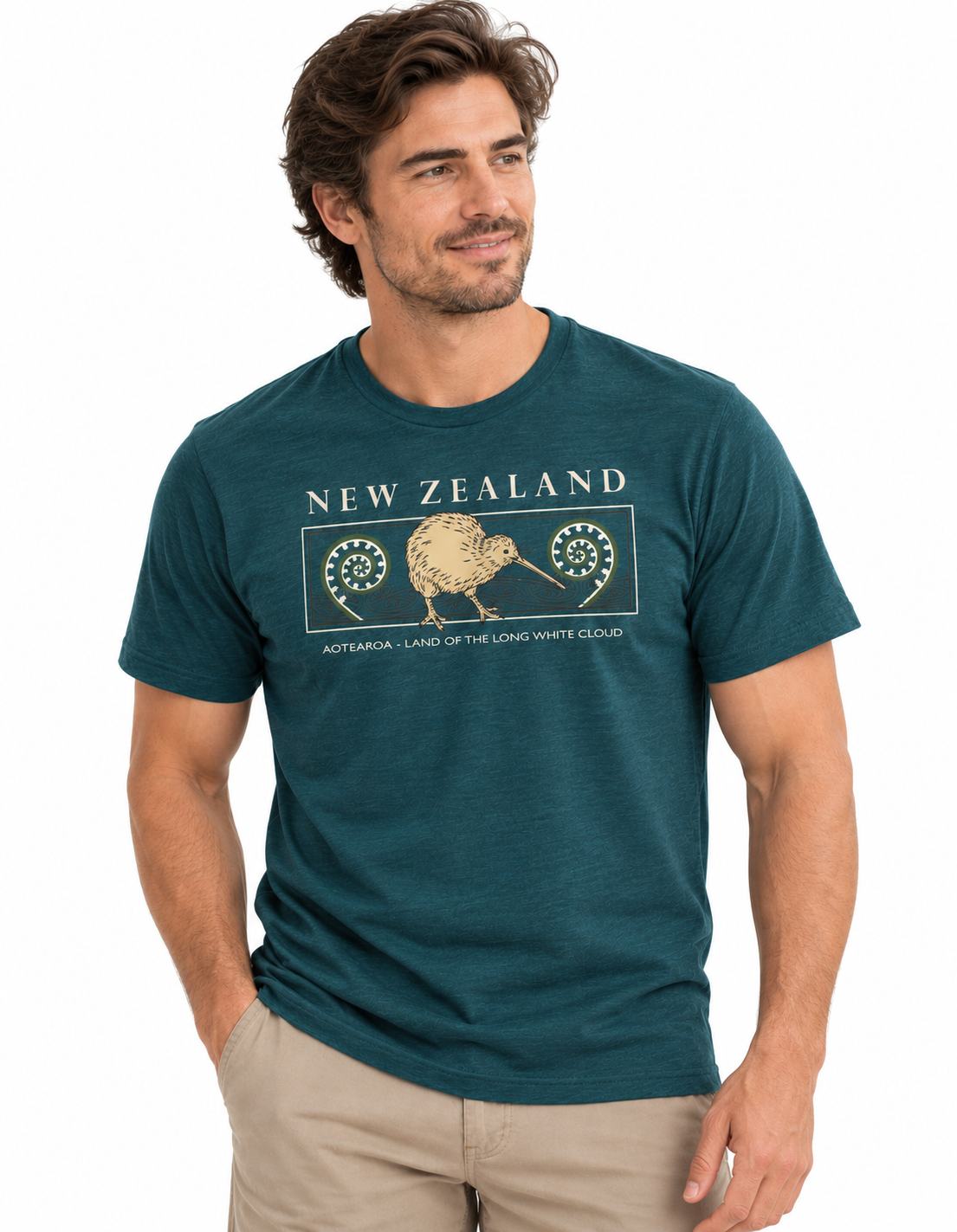 A man wearing a dark teal heathered t-shirt with a beige graphic of a kiwi bird and the text 'NEW ZEALAND' and 'AOTAROA - LAND OF THE LONG WHITE EAGLE'.