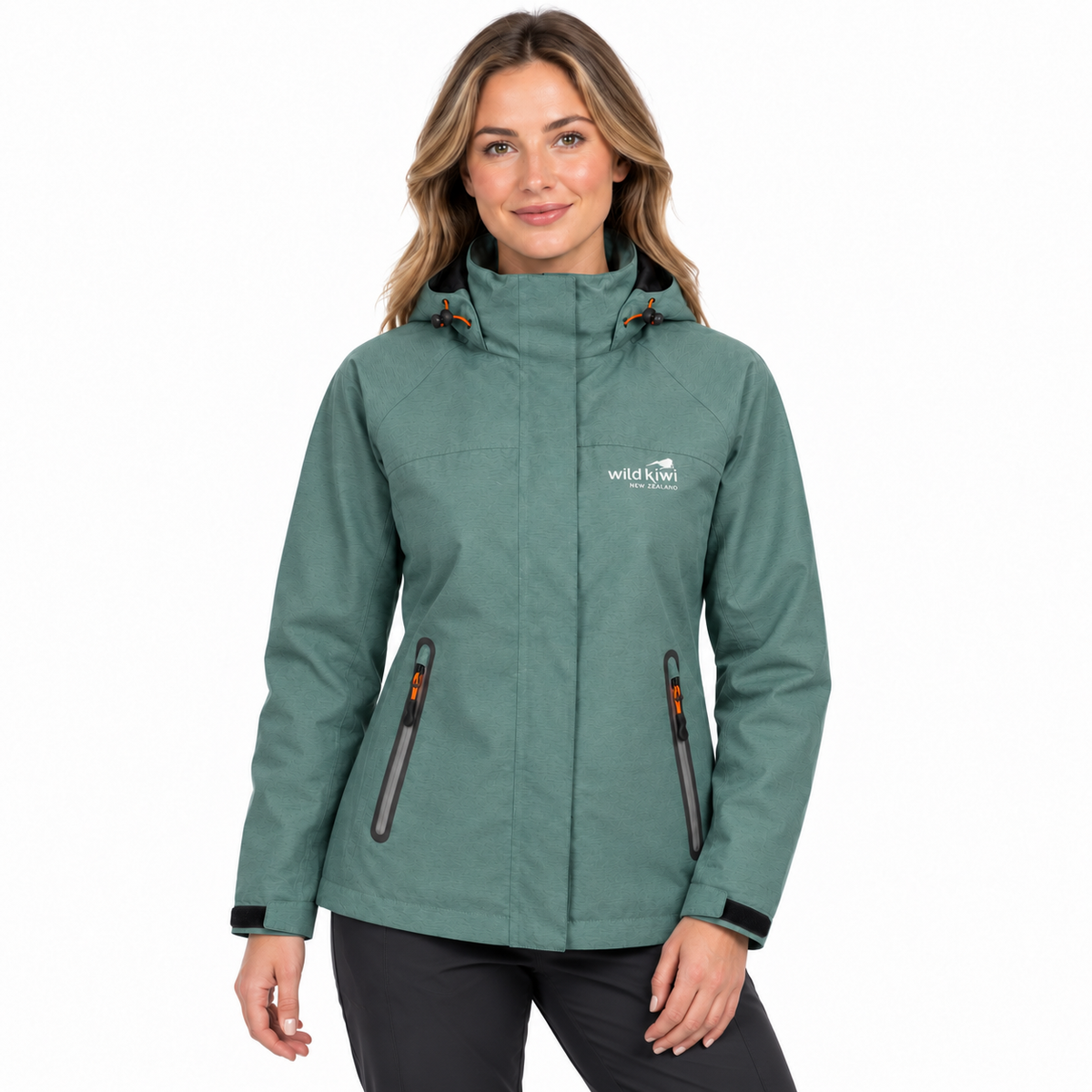 A woman modelling a sage green hooded outdoor jacket with zippered pockets and a white 'wild life' logo on the chest, set against a plain white background.