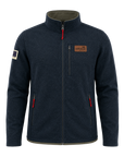 A dark navy blue fleece jacket with a stand-up collar, front zipper, zippered hand pockets, and red zipper pulls, shown on a plain white background. A brown brand patch is visible on the left chest, and a small sleeve patch is visible on the right sleeve.