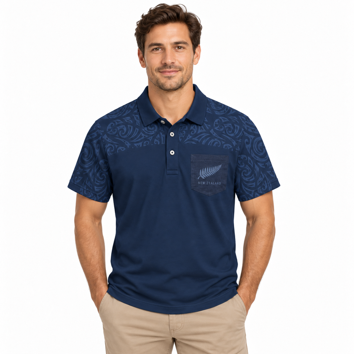 A man wearing a navy blue short-sleeve polo shirt with a subtle paisley pattern on the shoulders and a chest pocket featuring a silver fern logo and 'WELLINGTON' text, paired with khaki pants, against a plain white background.