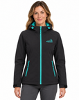 A woman modeling a black hooded softshell jacket with bright turquoise zipper and hood accent details, featuring a 'Wildawa' logo on the left chest, set against a plain white background.