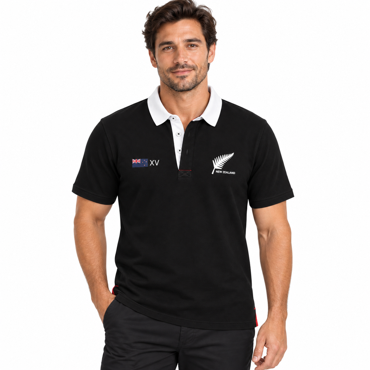 A man wearing a black short-sleeve polo shirt with a white collar. The shirt features the New Zealand fern logo on the left chest and a New Zealand XV match logo on the right chest.