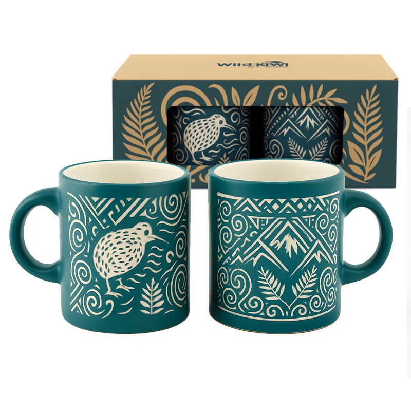Two teal ceramic mugs with white tribal-style patterns and a matching gift box behind them, photographed on a clean white background.