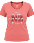 A coral pink short-sleeve scoop neck t-shirt featuring a 'New Zealand' graphic with the 'NZ' in maroon and white text, on a plain white background.