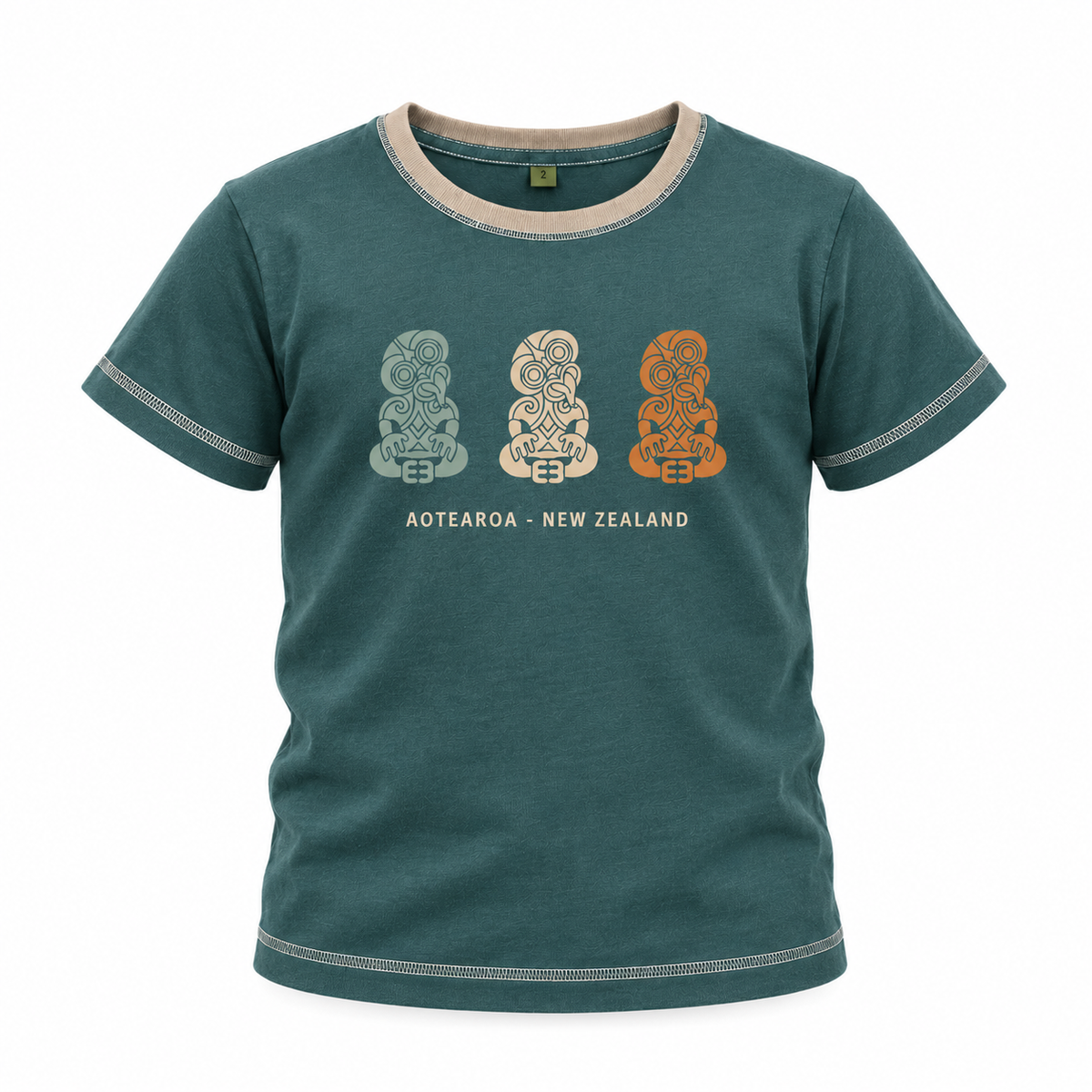 A short-sleeve crewneck t-shirt in washed teal green, featuring three Maori-style carved stone statues (Aotearoa) in light grey, cream, and terracotta orange on the chest, with 'AOTEAROA NEW ZEALAND' printed below. The t-shirt has a contrasting beige inner collar and visible contrast stitching along the edges.